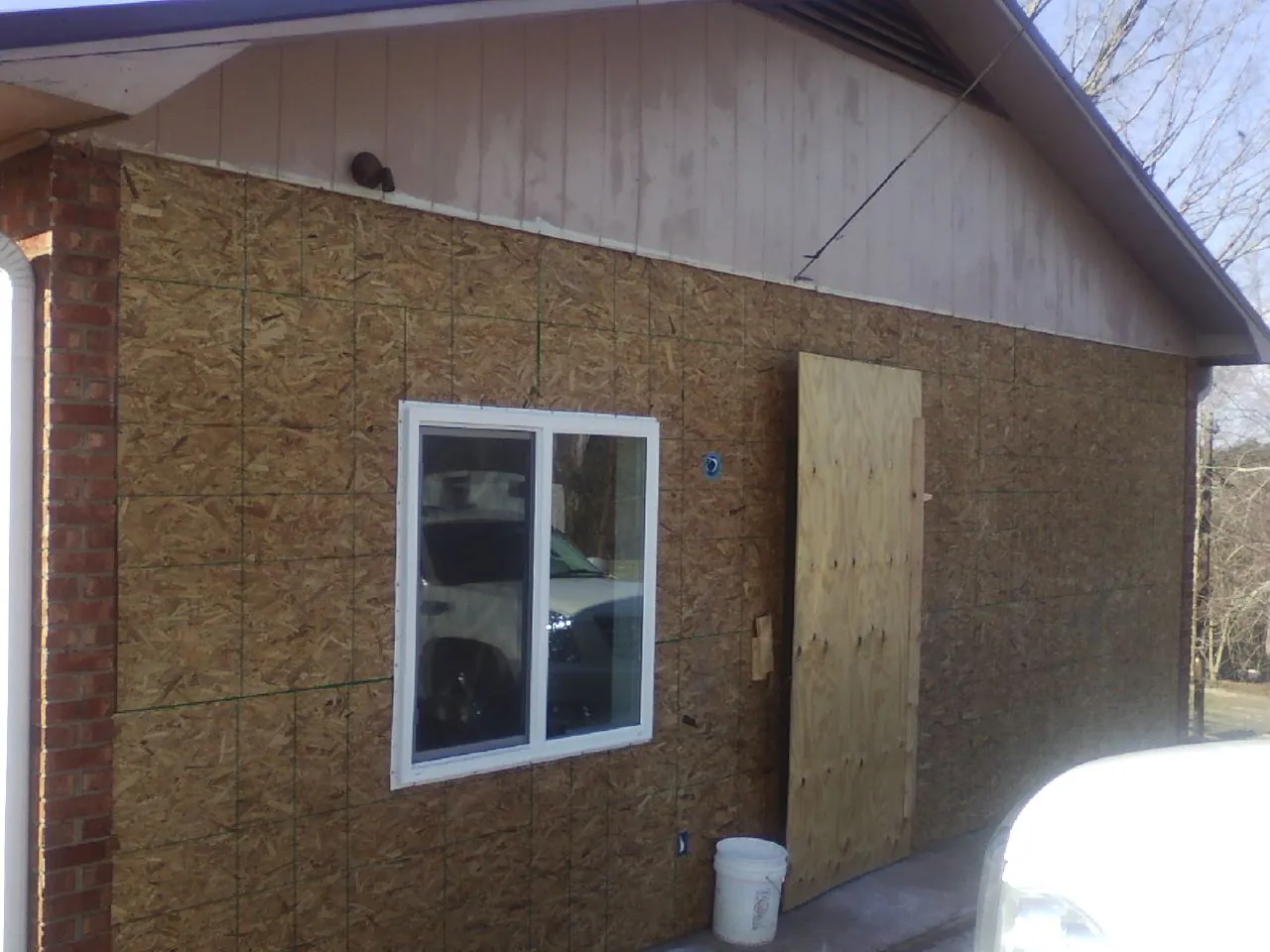 OSB sheathing on a garage addition wall before siding in Lykens