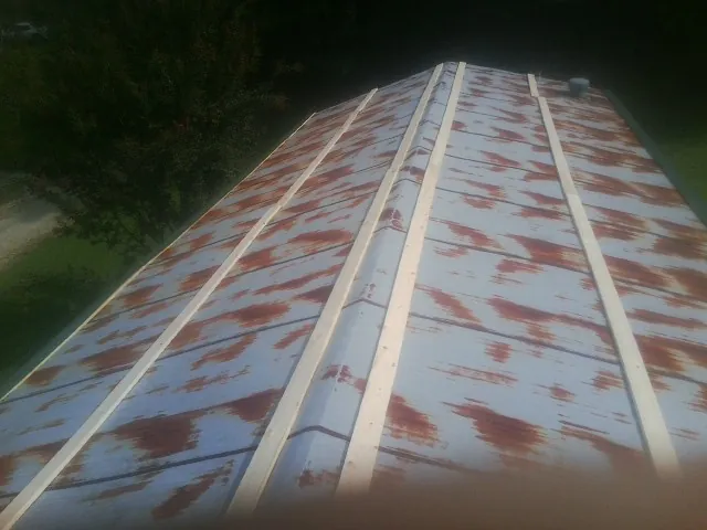 Rusted metal roof panels with new wood purlins before replacement — Storm Damage Roof Repair in Lykens by Roofing Brothers